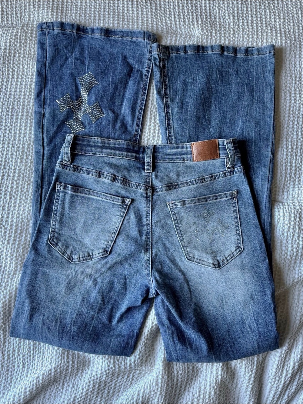 Project Rebel low rise Y2K-style cross bling flare jeans